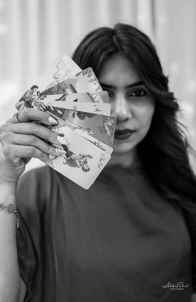 Portrait with tarot cards held near the face