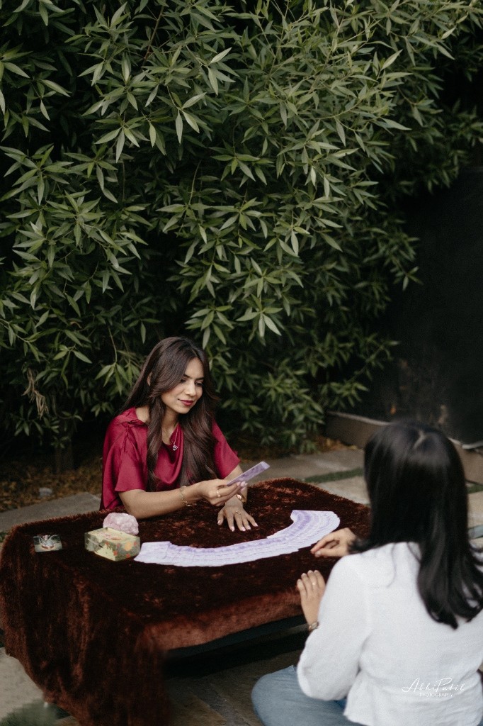 Tarot reading session with client seated across the table